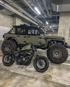 an off - road vehicle parked in a parking garage with two large tires on it