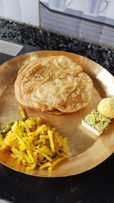 a plate with some food on it sitting on top of a counter next to a cup