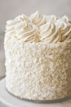 a close up of a cake with white frosting