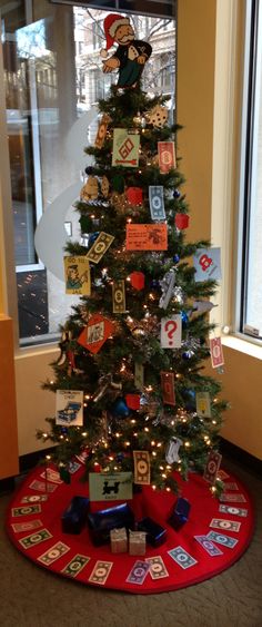 a decorated christmas tree in an office cubicle with lots of cards attached to it