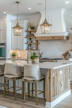 a kitchen with white cabinets and an island