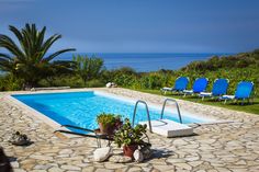 an empty swimming pool surrounded by lawn chairs