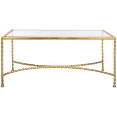 a gold coffee table with glass top