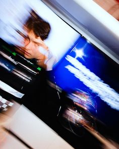 a blurry photo of a man in front of a television