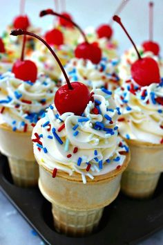 ice cream sundaes with cherries and sprinkles on a tray