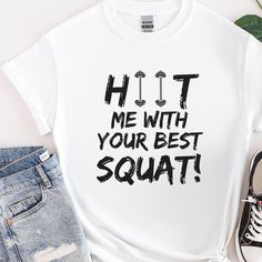 a white t - shirt with the words hit me with your best squat on it