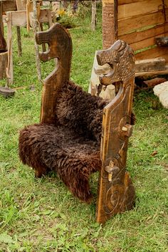 a chair made out of wood sitting in the grass