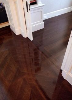 an empty room with wooden floors and white doors