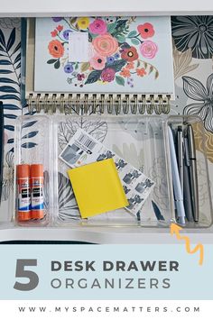 an organized desk with notebooks, pens and markers