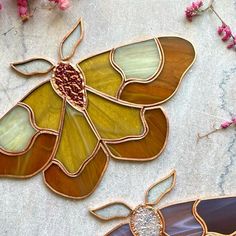 two stained glass butterflies sitting next to each other