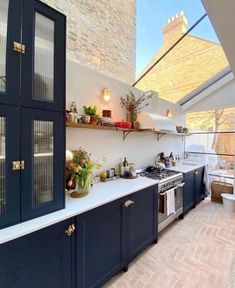 a kitchen with an open skylight above the stove and counter tops, is shown in this image