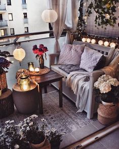 a couch and table on a balcony with lights