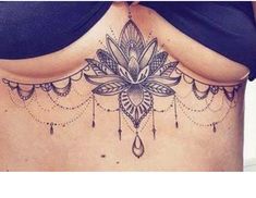 a woman's stomach with a tattoo on it