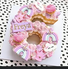 a pink and purple decorated doughnut on top of a white card