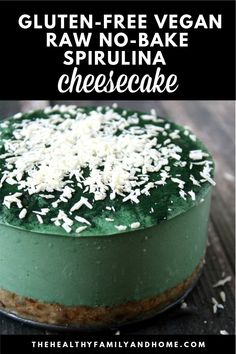 a green cake topped with white sprinkles on top of a wooden table