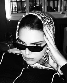 a woman with sunglasses and a scarf on her head