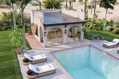 an aerial view of a pool with lounge chairs around it