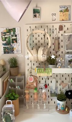 there are many items on the shelves in this room, including headphones and plants