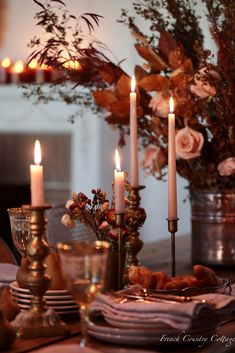 the table is set with candles and flowers