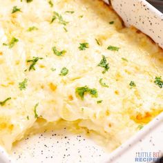 a casserole dish with cheese and herbs in it