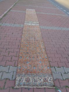 an old rug is laying on the sidewalk