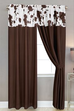 brown and white curtains hanging in front of a window