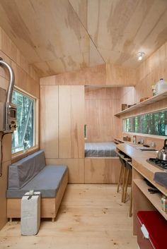 the interior of a tiny cabin with wood paneling