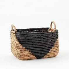 a black and tan basket with handles