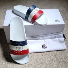 Brand New In Box Moncler Jeanne Slide Sandals In Gorgeous Signature Colors And Design! Moncler Logo Embossed, Made In Italy, 100% Rubber. Purchased For Pregnancy & Post-Pregnancy, But My Feet Never Grew! Open To Reasonable Offers Only, Will Counter Or Accept! Please Keep In Mind Posh Takes 20% When Sold. Save On Shipping: Make A Bundle Of At Least 2 Items & I'll Send You A Special Private Discount! Pics To Come Shortly! Designer White Sandals With Rubber Sole, White Casual Sandals With Red Sole, Casual White Sandals With Red Sole, Designer White Leather Slides, Designer White Round Toe Sandals, White Open Toe Sandals With Red Sole, Designer White Sandals With Cushioned Footbed, Luxury White Slip-on Slides, Designer White Slides For Summer