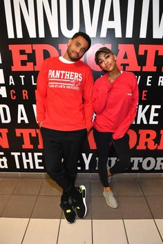 two people standing in front of a sign that says innovativve and breathe