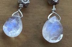 These amazing moonstone drops capture the beauty of crystals and blue skies at the same time. Blue flashes are produced from many angles where the light strikes these beautiful teardrop earrings. The sterling silver version is enhanced by a Karen Hill Tribe bead and ear wires. Stunning present for any nature lover! Elegant mother's Day gift. Also available in a gold filled version: https://etsy.me/3v51Xya Faceted Moonstone Teardrop Earrings, Teardrop Moonstone Faceted Earrings, Handmade Moonstone Drop Crystal Earrings, Spiritual Moonstone Teardrop Earrings, Celestial Silver Moonstone Earrings, Silver Dangle Moonstone Crystal Earrings, Silver Moonstone Dangle Crystal Earrings, Handmade Silver Moonstone Crystal Earrings, Handmade White Moonstone Crystal Earrings