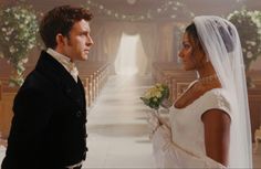 a man and woman standing in front of pews at a wedding ceremony, looking into each other's eyes