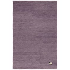 a purple rug with a sheep on the front and bottom corner, in an area that is