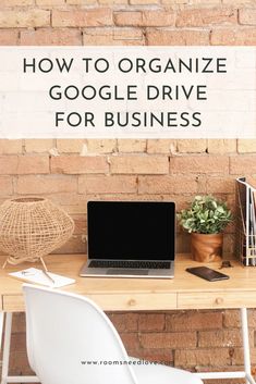 a laptop computer sitting on top of a wooden desk next to a white chair and potted plant