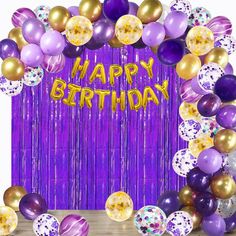 a purple and gold birthday backdrop with balloons