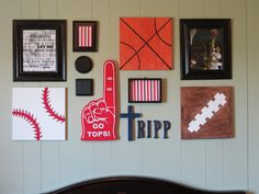 a bedroom wall with pictures and sports related items on it