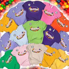 a bunch of shirts that are in front of some gummy balls on a table