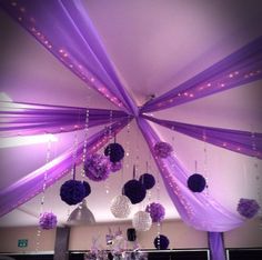 purple and white decorations hanging from the ceiling