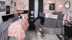 a bedroom decorated in pink and grey with pictures on the wall, bedding and rugs