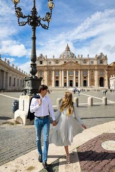 a man and woman walking in front of a building