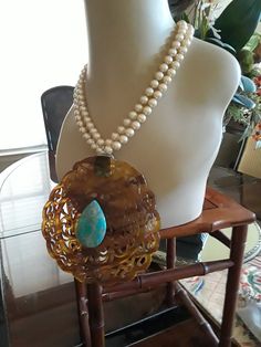 "A show stopper two strand pearl necklace measuring 17\" long. The pears measure 8mm. The turtouis antique hair comb, I have repurposed into this fabulous pendant. The center turquoise imperial jasper measures 1 1/2\" long and 1 1/4\" wide.. The backside of this turtouis shell, I attached a turquoise Sterling piece to loop the pearls through. This is one of my favorite creations. Looks great for that special occasion." Elegant Double Strand Turquoise Necklace, Elegant Turquoise Necklace With Large Pendant, Elegant Round Turquoise Necklace With Large Pendant, Elegant Oval Turquoise Necklace With Large Pendant, Antique Hair Combs, Creative Necklace, Imperial Jasper, Black Onyx Necklace, Garnet Necklace