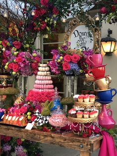 a table topped with lots of different types of cakes and cupcakes on top of it