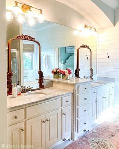 a large bathroom with double sinks and mirrors