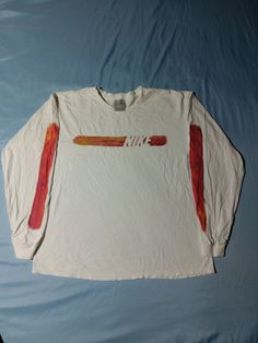 Very unique Nike long sleeve from the early 2000s! EXACT MEASUREMENTS IN PICS AND LISTING. Amazing arm hits on both sleeves with rainbow gradient colors of red and orange. Rare silver tag and high quality early 2000s vintage. Perfect tee for the surf or beach this summer. Approx. 22 X 26 and tagged M. See pics for size and details! Vintage Early 2000s Y2K Nike Art Long Sleeve Streetwear Surfwear Surf Surfing Beach Summer T-Shirt, Silver Tag M Y2k Long Sleeve Screen Print T-shirt, Y2k Long Sleeve T-shirt With Screen Print, Long Sleeve Y2k T-shirt With Screen Print, Red Long Sleeve T-shirt Y2k Style, Red Long Sleeve Y2k T-shirt, Multicolor Long Sleeve T-shirt With Screen Print, 90s Long Sleeve T-shirt For Fall, 90s Style Long Sleeve T-shirt For Fall, Multicolor Long Sleeve Tops With Graphic Design