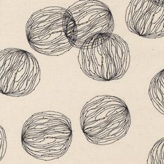 several balls of yarn are shown in black and white on a linen background, with lines drawn across them