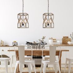 two chandeliers hanging from the ceiling over a dining room table with white chairs