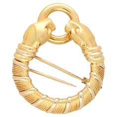 A beautiful vintage Cartier Panthère double headed brooch set in 18k yellow and white gold. From a discontinued Cartier collection, the brooch depicts a double headed panther; both of which are grasping a polish yellow gold ring. The body of the panther heads is composed of a coiled design which looks fantastic once on a jumper or coat. The coils reflect elegantly off the light, highlighting the grooves and detailing within the piece. This piece really shows the excellent craftsmanship of the ea Cartier Jewellery, Cartier Collection, Cartier Panthere, Cartier Jewelry, Gold Box, Jewellery Uk, Gold Brooches, Yellow Gold Ring, Vintage Cartier