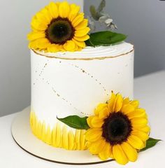 a white cake with sunflowers on top