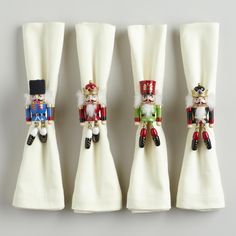 four napkin holders with nutcrackers on them