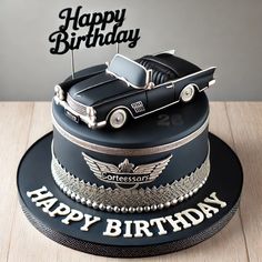 a birthday cake with a black car and happy birthday topper on the bottom layer